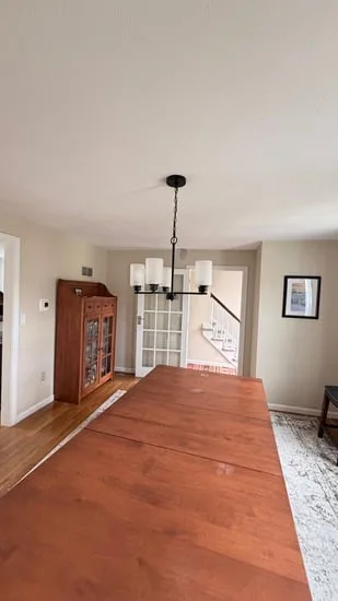 A completed chandelier installation Southborough project showing the new fixture and a cleanly patched ceiling.